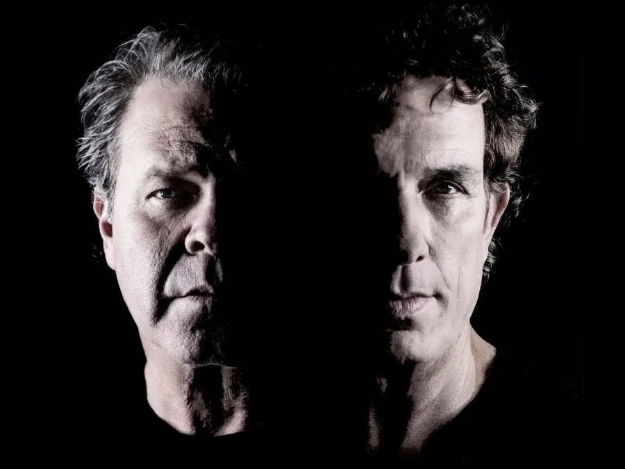 Ian Moss and Troy Cassar-Daley posing in front of black background.