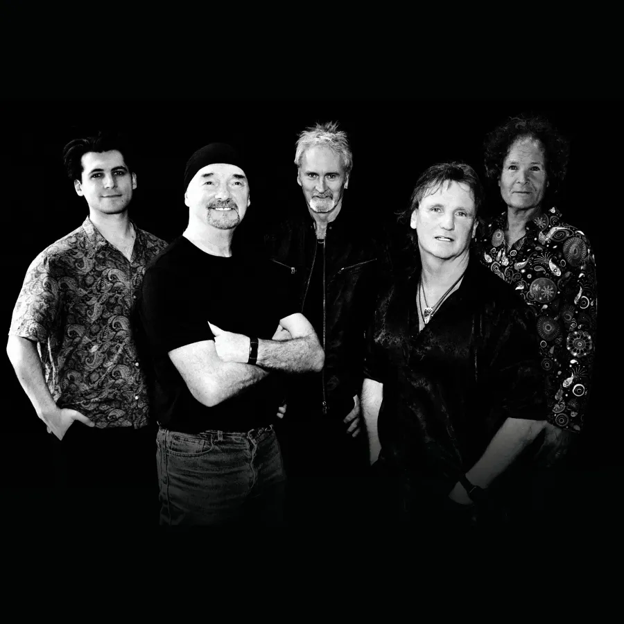 Smokie Smokie posing in front of black background