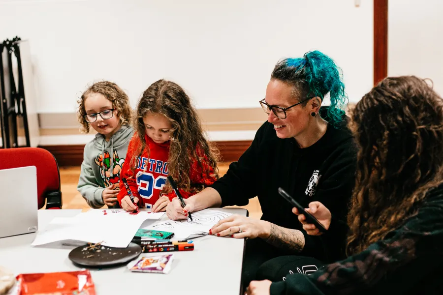 Nikki Mckenzie working on an art piece with her children Workshop facilitator Nikki Mckenzie working on an art piece with her children.