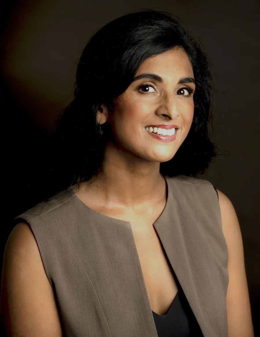Sonya Suares posing in front of dark background