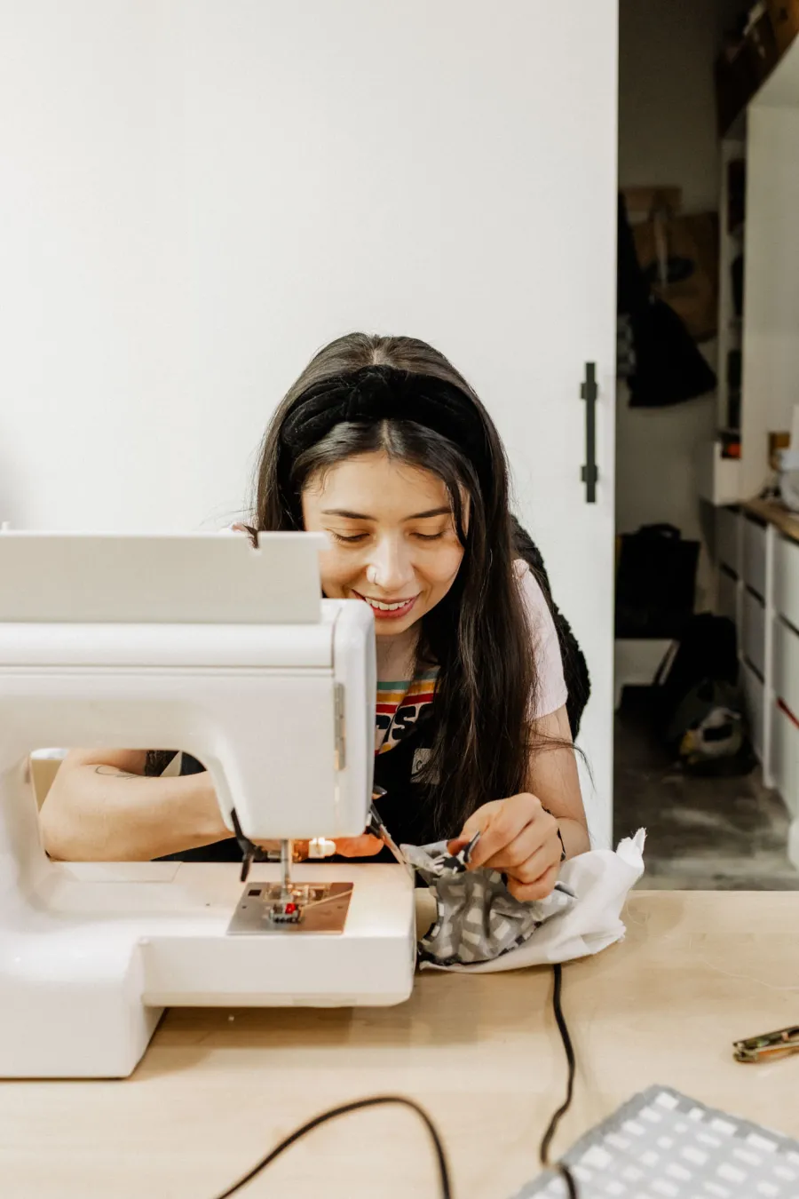 Image of a lady at her sewing machine