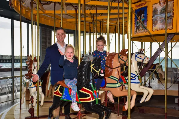 Greater Geelong Mayor Trent Sullivan joins Eden (left) and Violet in celebrating the Carousel's extended opening hours.