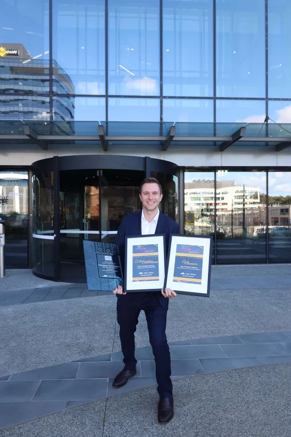 Mayor Trent Sullivan holding the award and commendation certificates.