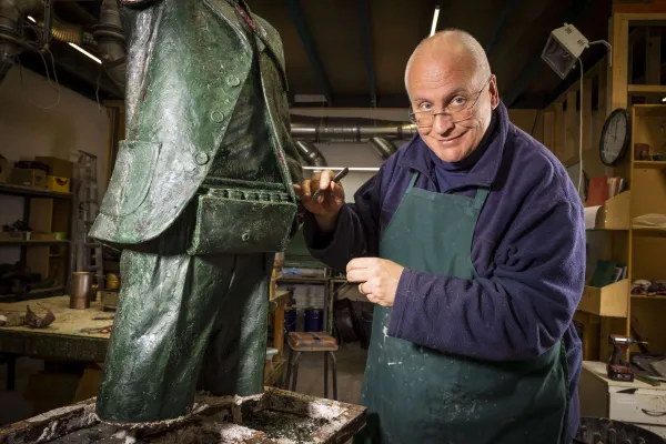 Artist Louis Laumen working on the Frank Costa statue
