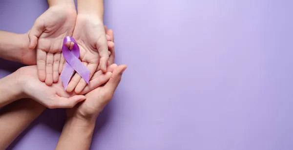 Overlapping hands on purple background and purple ribbon.