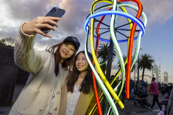 WhiteNight_UnderTheNeonSea-2433.jpg Two women taking a selfie at Cunningham Pier during White Night event.