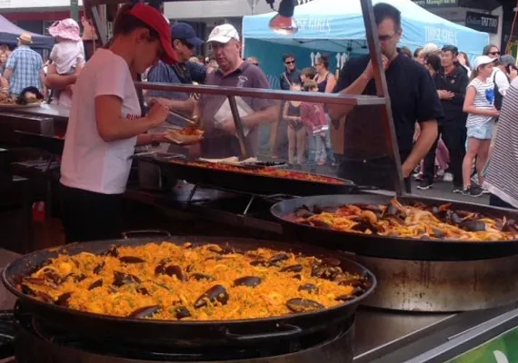 Business and investment multicultural Geelong People cooking paella at a festival