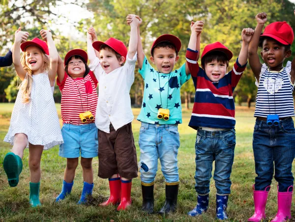 Children's Week Grants - header image Children outside with hand in the air