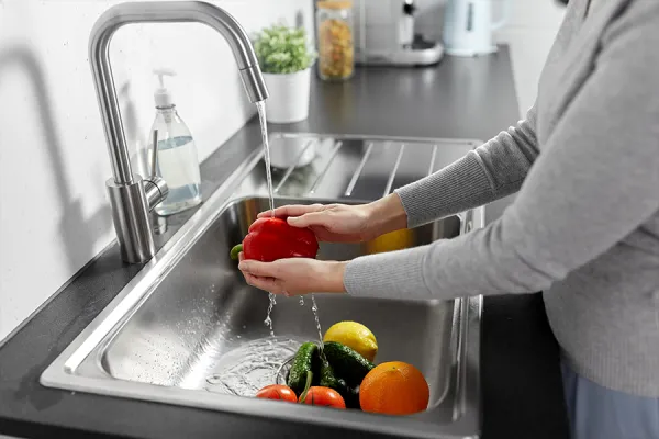 Food safety Person washing fruit and vegetables.