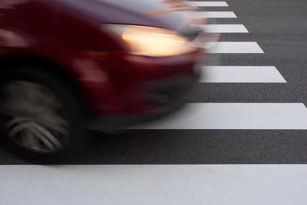 Hoon Car driving fast over a zebra crossing.