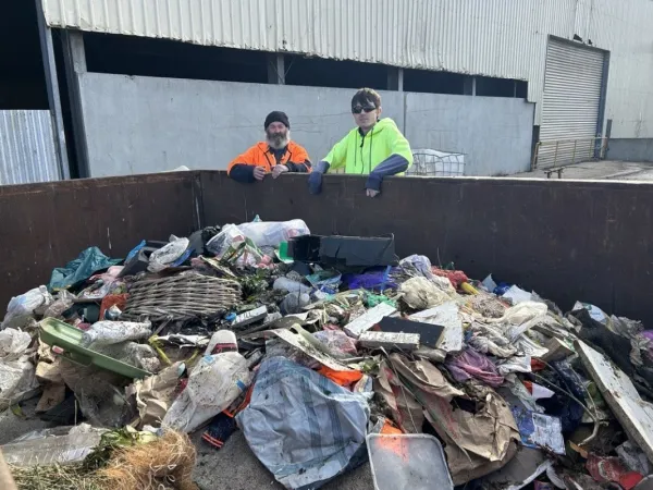 A day in the life of the organics pickers Jack and Robbie in front of contamination removed from the garden organics bins