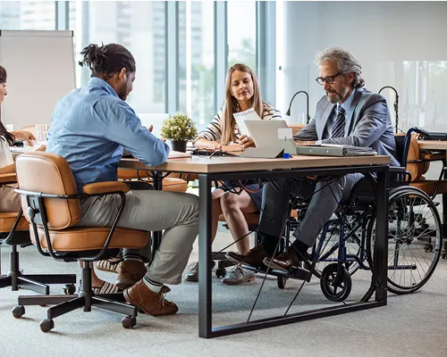 Four people sitting around a table for a meeting. 