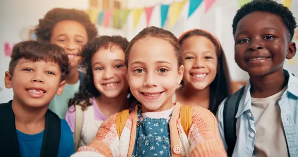 Six children smiling in a photo