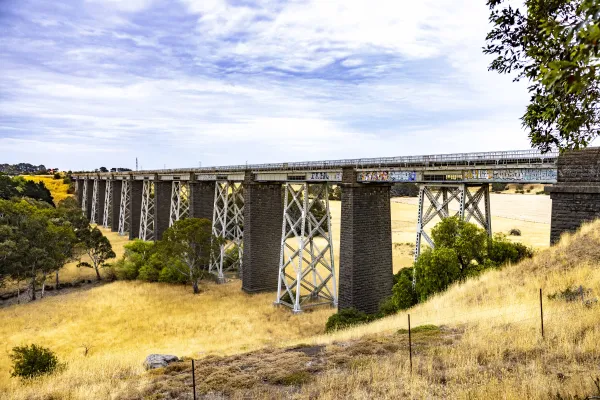Historic Moorabool Viaduct spanning yellow fields and green trees