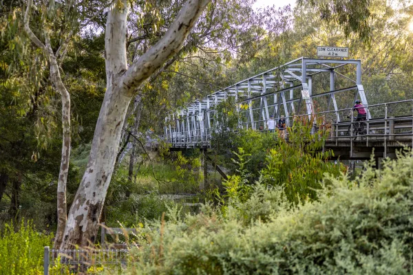Cyclists crossing the Queens Park Bridge