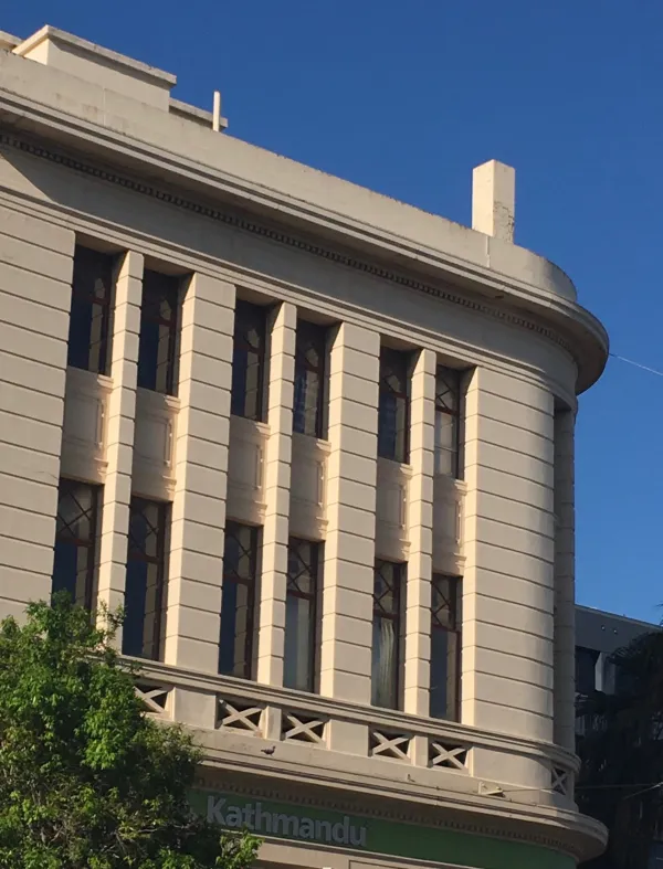 National Bank Rounded white brick facade with long narrow windows and Greek style details