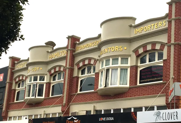 Scott Hamilton and Co. Ironmongers Redbrick facade of Federation Freestyle building with white trimmed windows and gold letters across the top