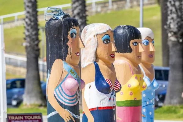 Bathing Beauties Painted bollards of four beauty contestants all wearing bathing suits and make-up.
