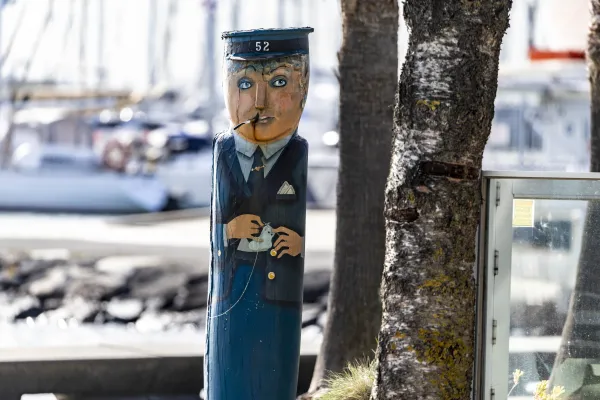 Tram Conductress Painted bollard of a woman dressed in a tram conductors' outfit with blue hat and a tram ticket in her hand.