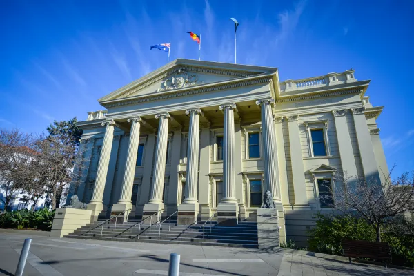 City Hall Heritage listed building with large roman columns and stairs with lion statues on either side.