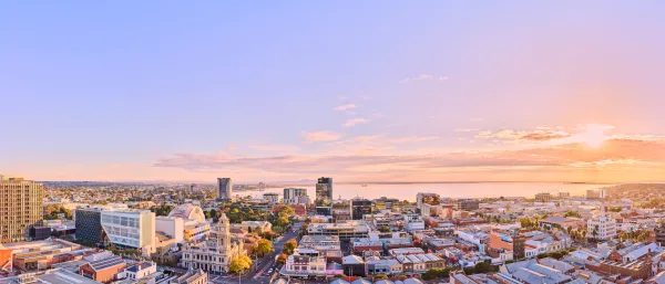 Aerial view of central Geelong looking across rooftops and skyline towards Corio Bay