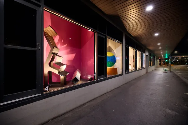 Yarra Street Window Gallery street at night with lit windows with artwork in each section