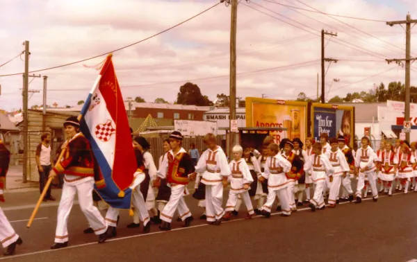 People marching on a road in cultural dress