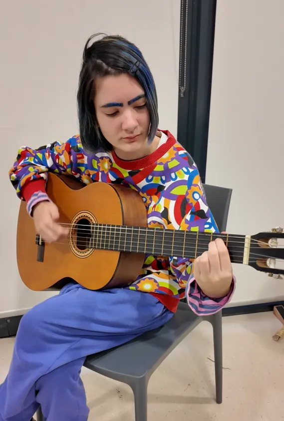 Young person playing the guitar