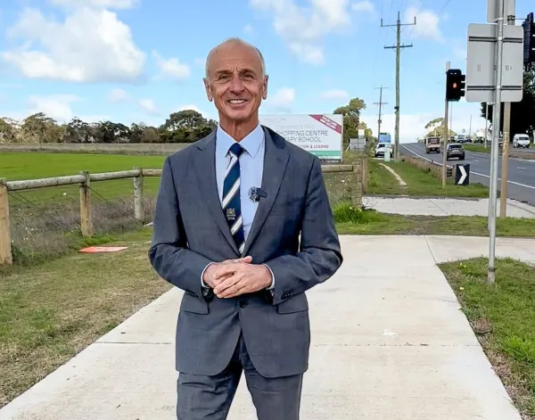 Mayor Stretch Kontelj OAM stands at intersection of Baanip Boulevard and Surf Coast Highway