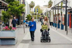 Accessibility_Of_Geelong.jpg Woman in wheel chair with carer and man walking through Lt Malop Street.