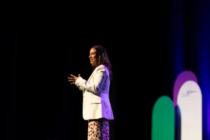 Woman standing on stage making a speech