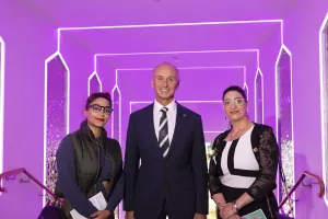 Mayor standing with two guests
