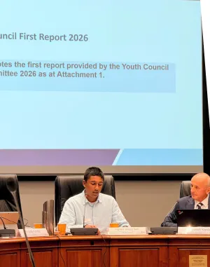 Young person making a presentation while sitting behind a desk