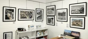 Seven framed photographs on a gallery wall