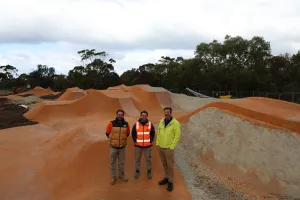 Three men standing on a jump park