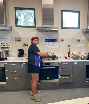 Young person cooking on a stove
