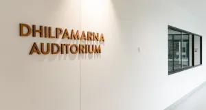 Timber lettering spells out Dhilpamarna Auditorium