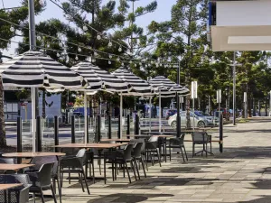 Image of chairs and tables with umbrellas