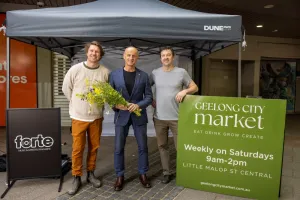 Mayor Stretch Kontelj (centre) with Simon Toohey and Kieran Blood of Barwon Events. The mayor stands in the middle holding flowers.