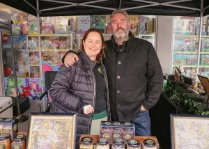 Maryanne and Jarrod Wallis of The Bush Honey Co standing at their stall at Geelong City Market
