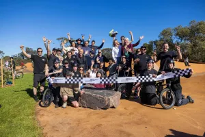 People posing before a ceremonial ribbon