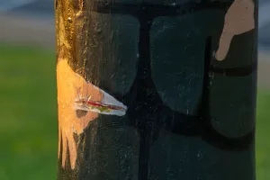 Painted small sandwich held by bollard