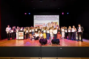 A group of people standing on a stage.