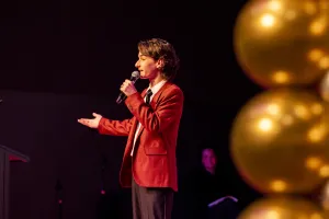 Young person standing on a stage.
