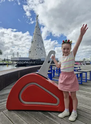 Competition winner Charlotte gets ready to flick the switch of the Floating Christmas Tree