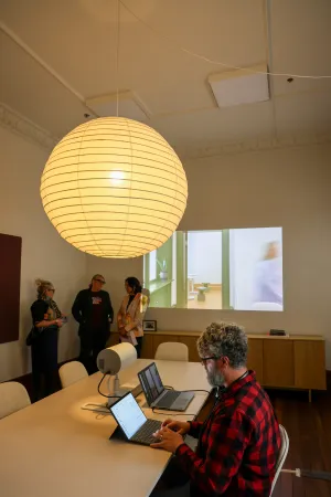 People talking or working on a laptop